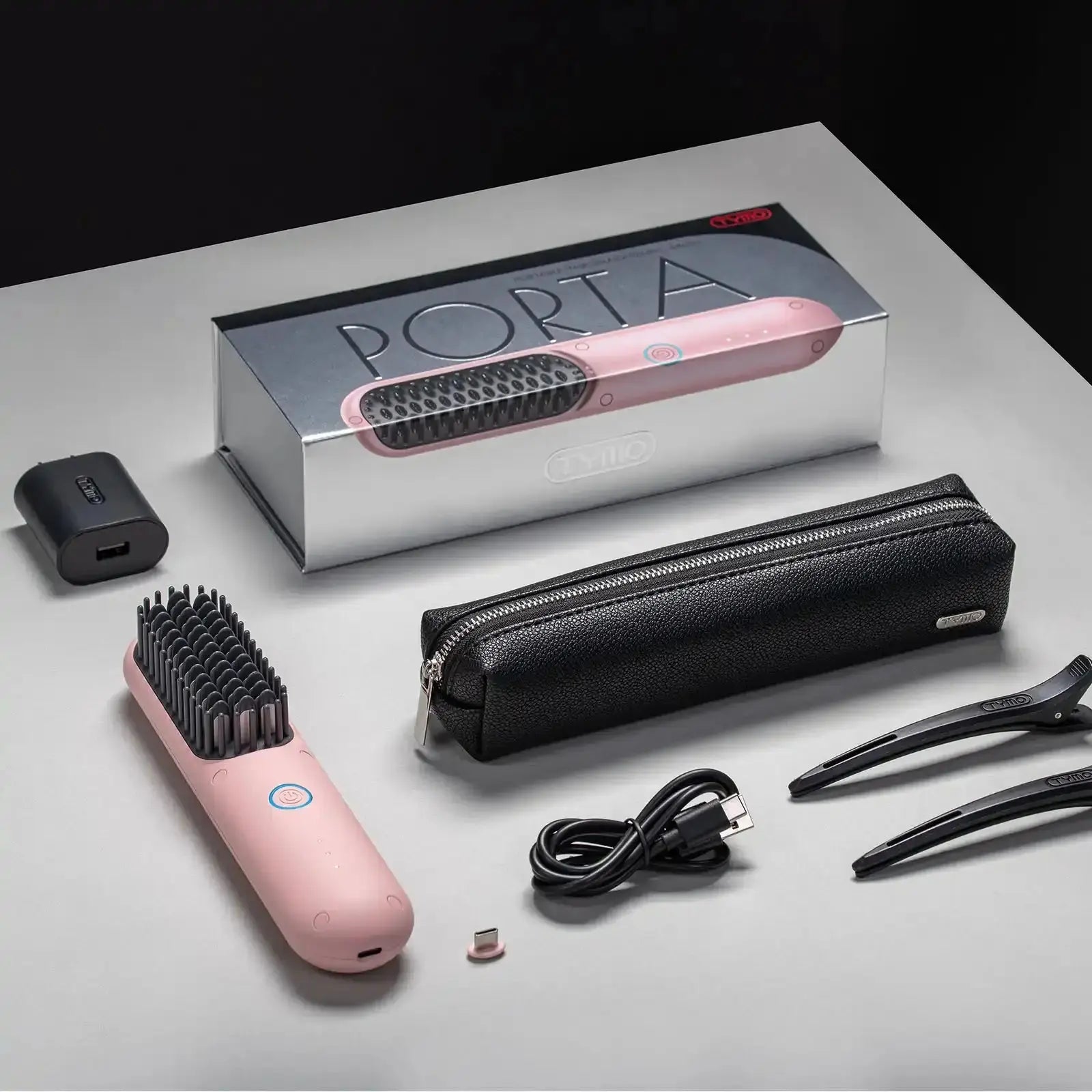 Packaging of TYMO PORTA PINK wireless hair straightener including brush, carrying case, USB cable, and accessories.